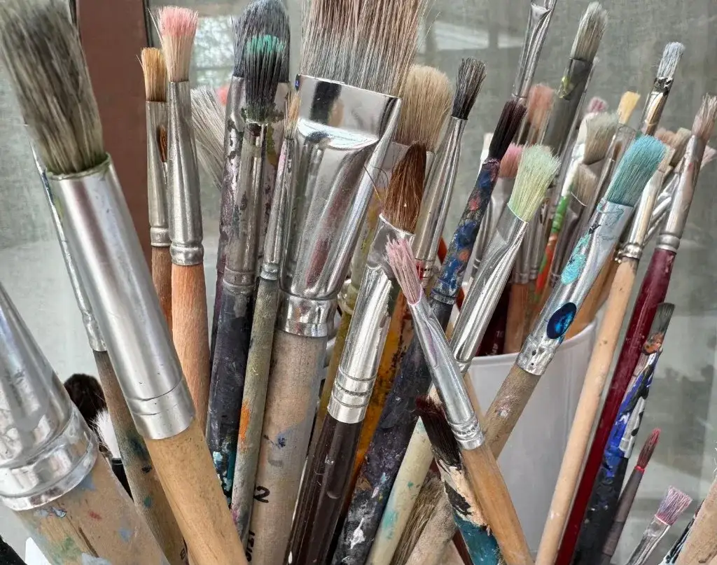 Viele Malpinsel mit Farbspuren im Atelier · OFFStudio Dreieich